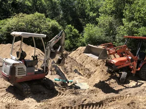 Septic system excavation using compact equipment