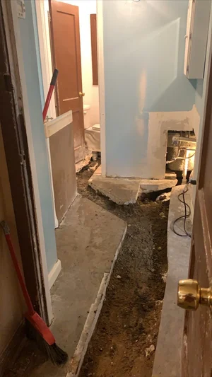 Interior concrete slab trench opened for pipe replacement
